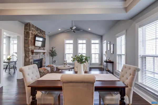 a dining room with furniture a window and wooden floor
