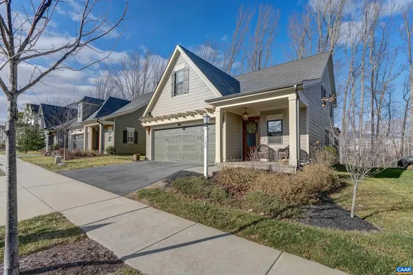 a view of house with yard and front view of a house