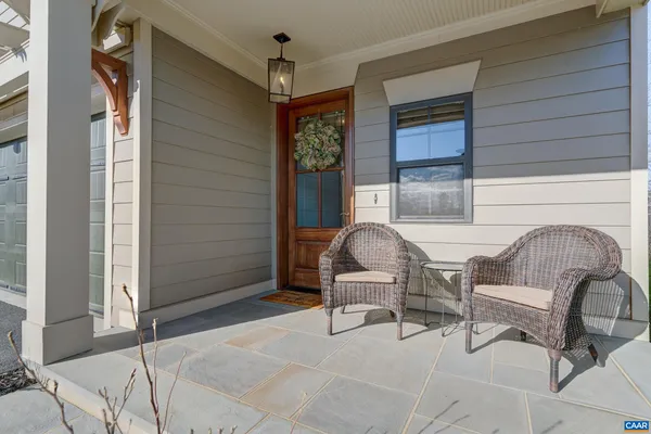 a balcony with table and chairs