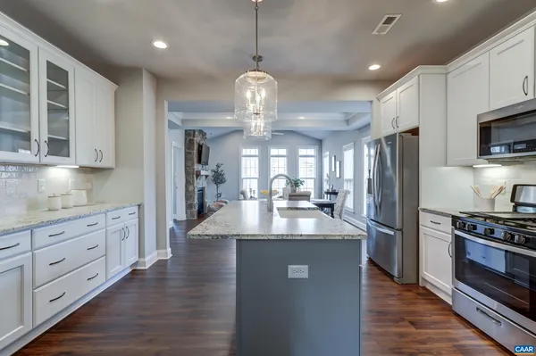 a view of a kitchen center island cabinets and stainless steel appliances