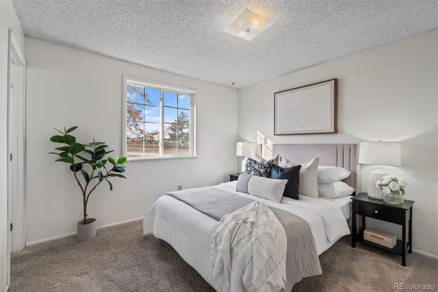 a bedroom with bed and a window