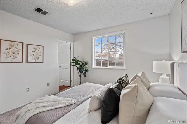 a bed room with a bed and a window