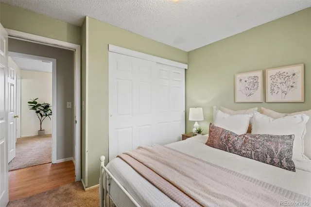 a bedroom with a bed and a painting on the wall