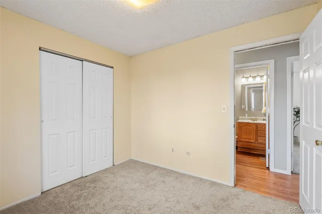 an empty room with closet and a bathroom