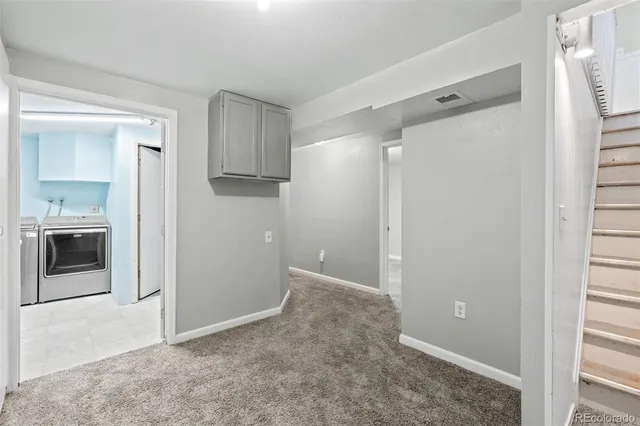 a view of an empty room with a kitchen