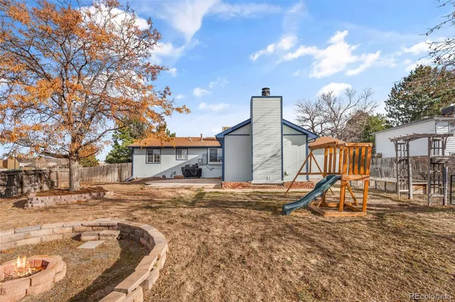 a backyard of a house with table and chairs