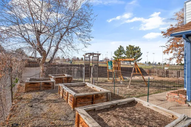 a view of backyard with wooden fence