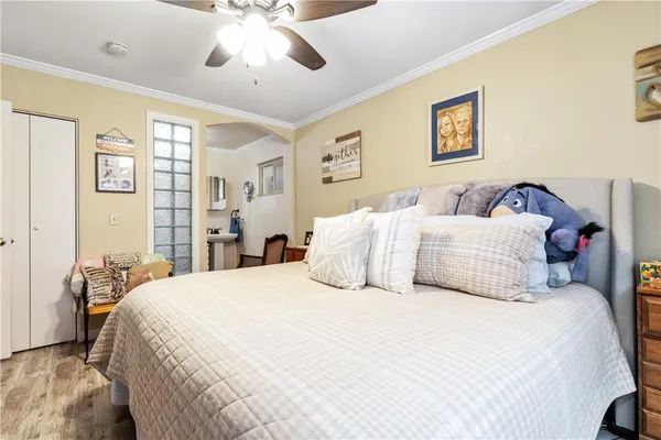 a bedroom with a large bed and a chandelier