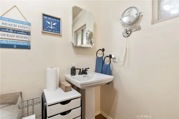 a bathroom with a sink a mirror and a toilet