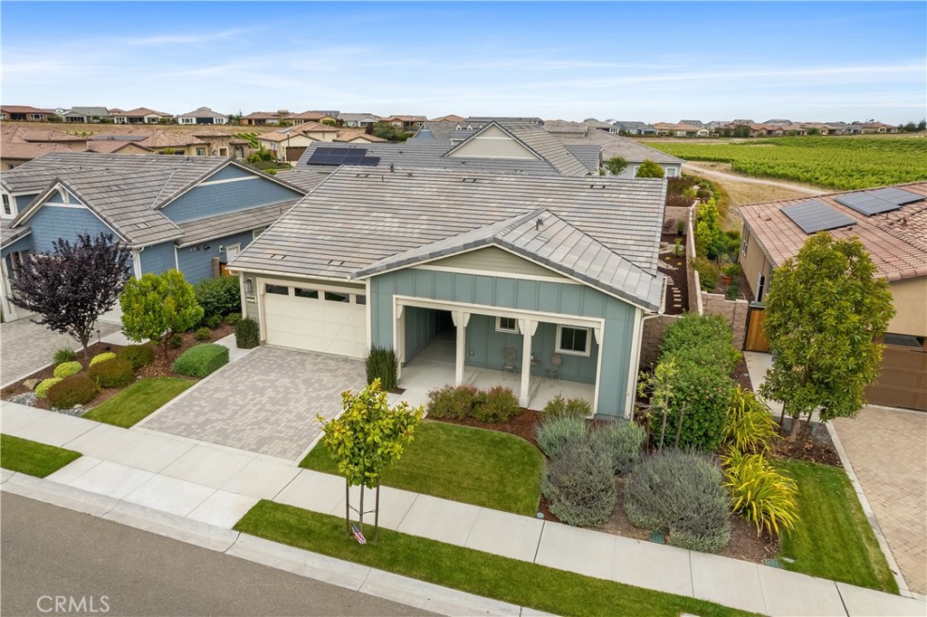 an aerial view of a house with a garden and lake view