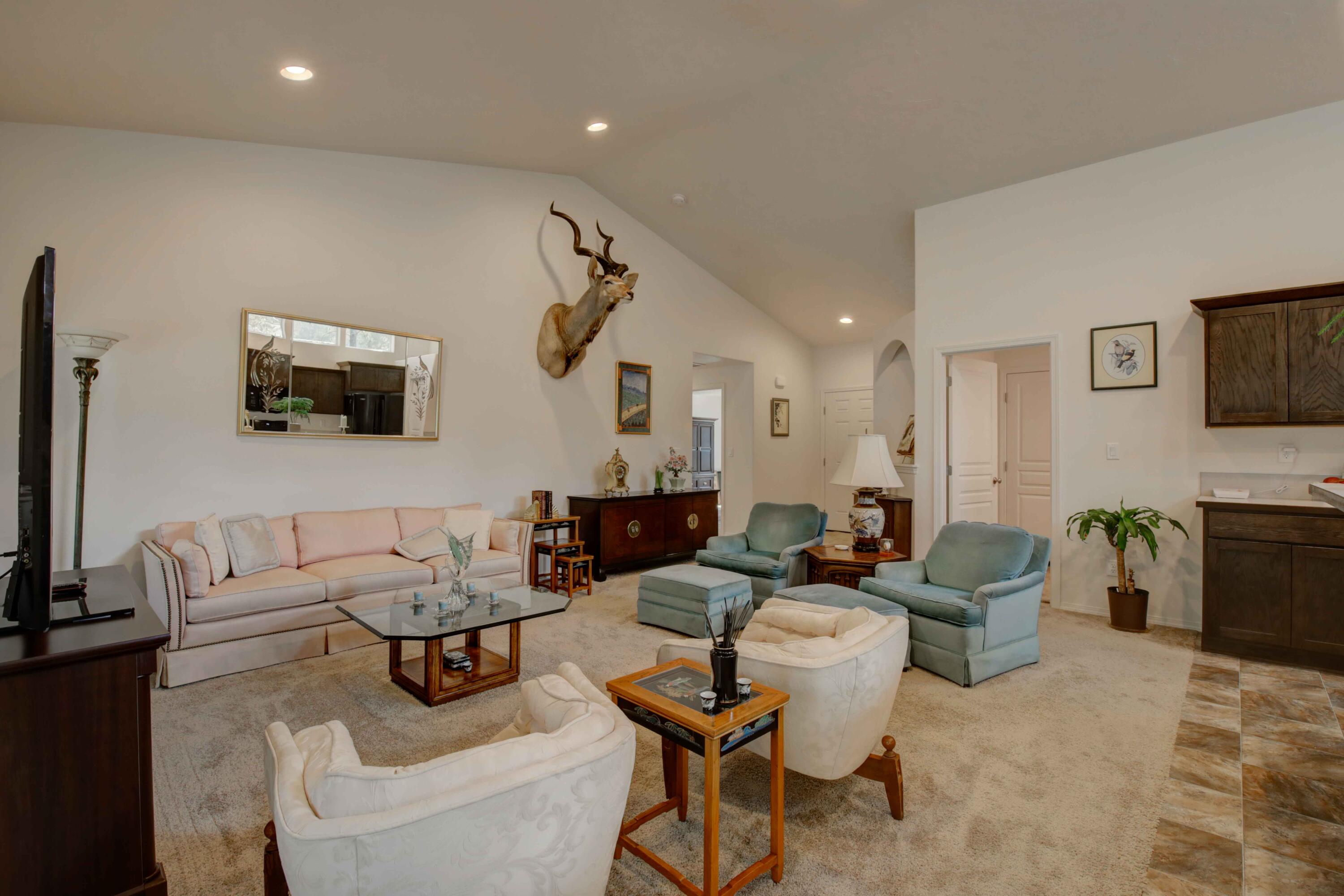 17160 Elsinore Road Bend, OR 97707 - Photo 12 of 47 a living room with furniture a flat screen tv and a fireplace