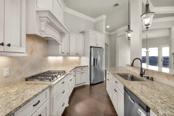 an empty room with windows and ceiling fan
