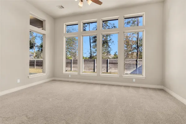 an empty room with fan and entrance