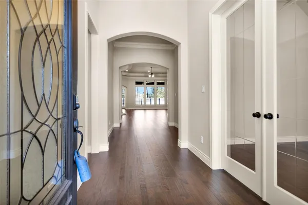 a view of a hallway with wooden floor and entryway