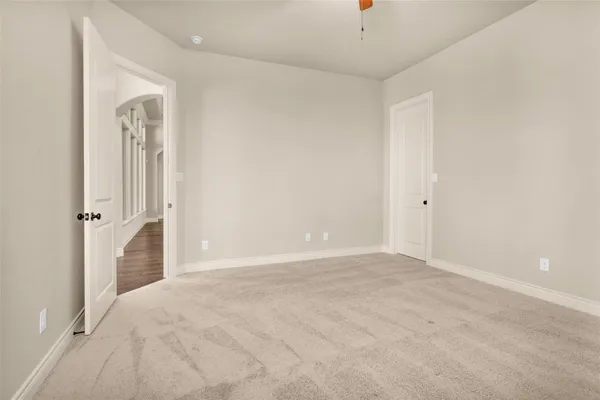 an empty room with windows and closet
