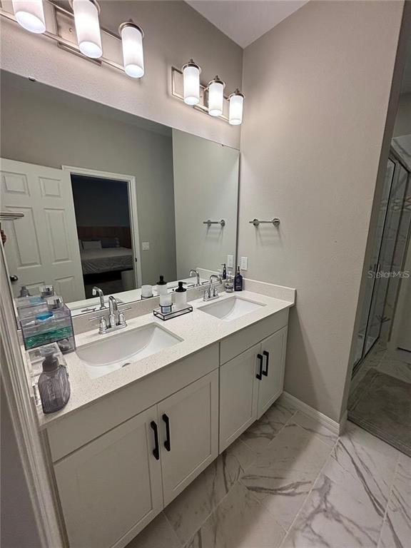 4812 Lime Rickey Alley Winter Garden, FL 34787 - Photo 11 of 19 a bathroom with a sink and a mirror