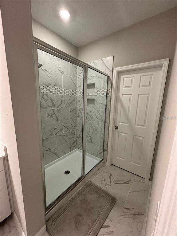 4812 Lime Rickey Alley Winter Garden, FL 34787 - Photo 12 of 19 a bathroom with a shower and a sink