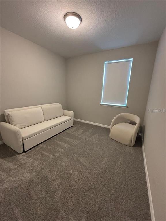 4812 Lime Rickey Alley Winter Garden, FL 34787 - Photo 16 of 19 a living room with furniture and a window