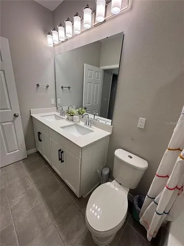 a white toilet sitting next to a bathroom sink