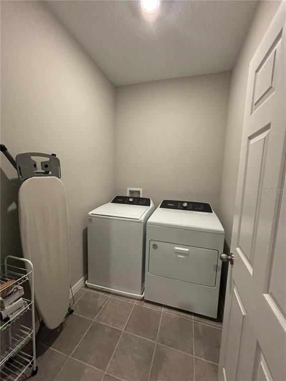 4812 Lime Rickey Alley Winter Garden, FL 34787 - Photo 19 of 19 a utility room with dryer and washer