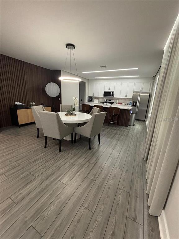 4812 Lime Rickey Alley Winter Garden, FL 34787 - Photo 3 of 19 a living room with couches chairs and a fireplace with wooden floor