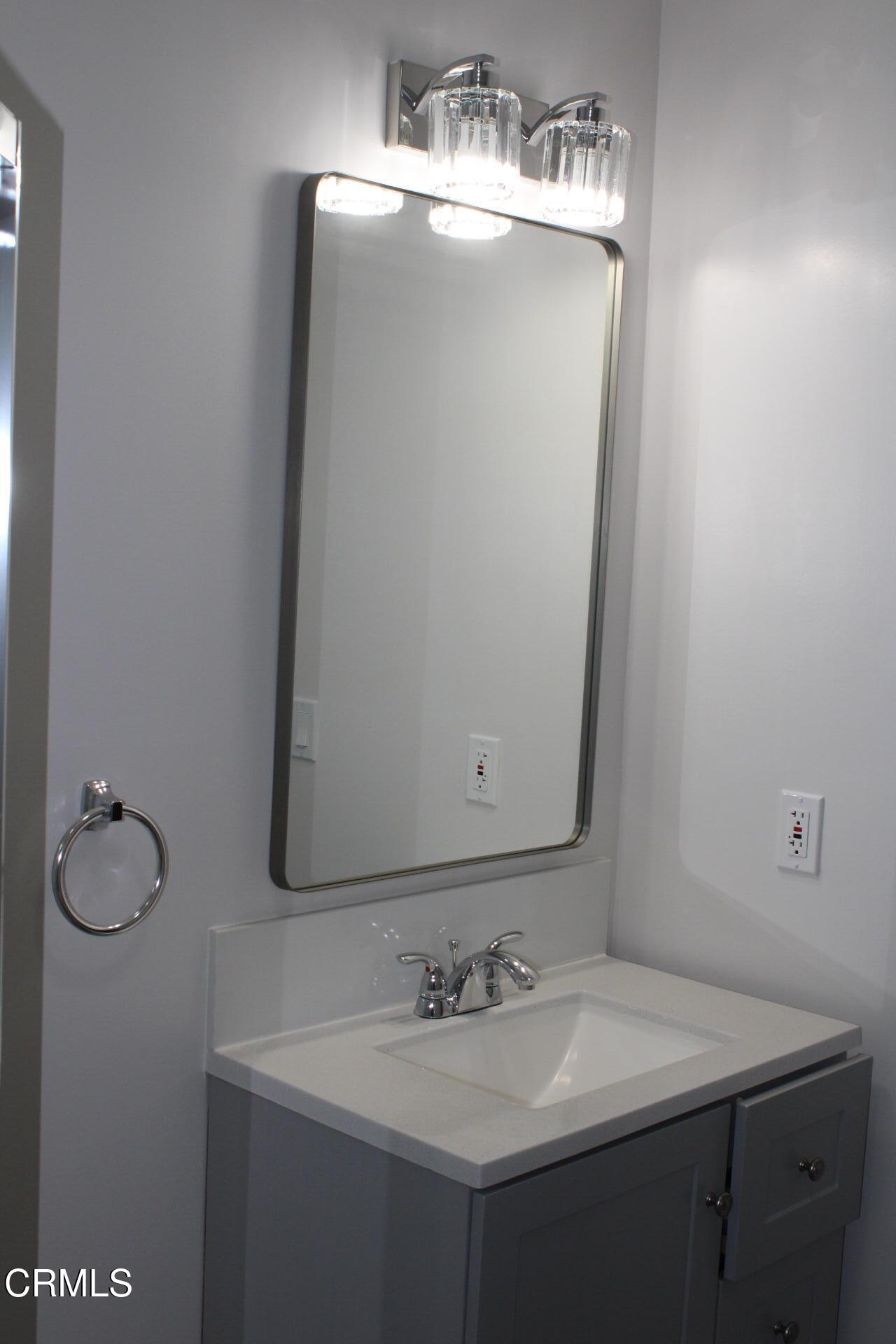 10031 Marcus Avenue Tujunga, CA 91042 - Photo 18 of 27 a bathroom with a sink vanity and a mirror