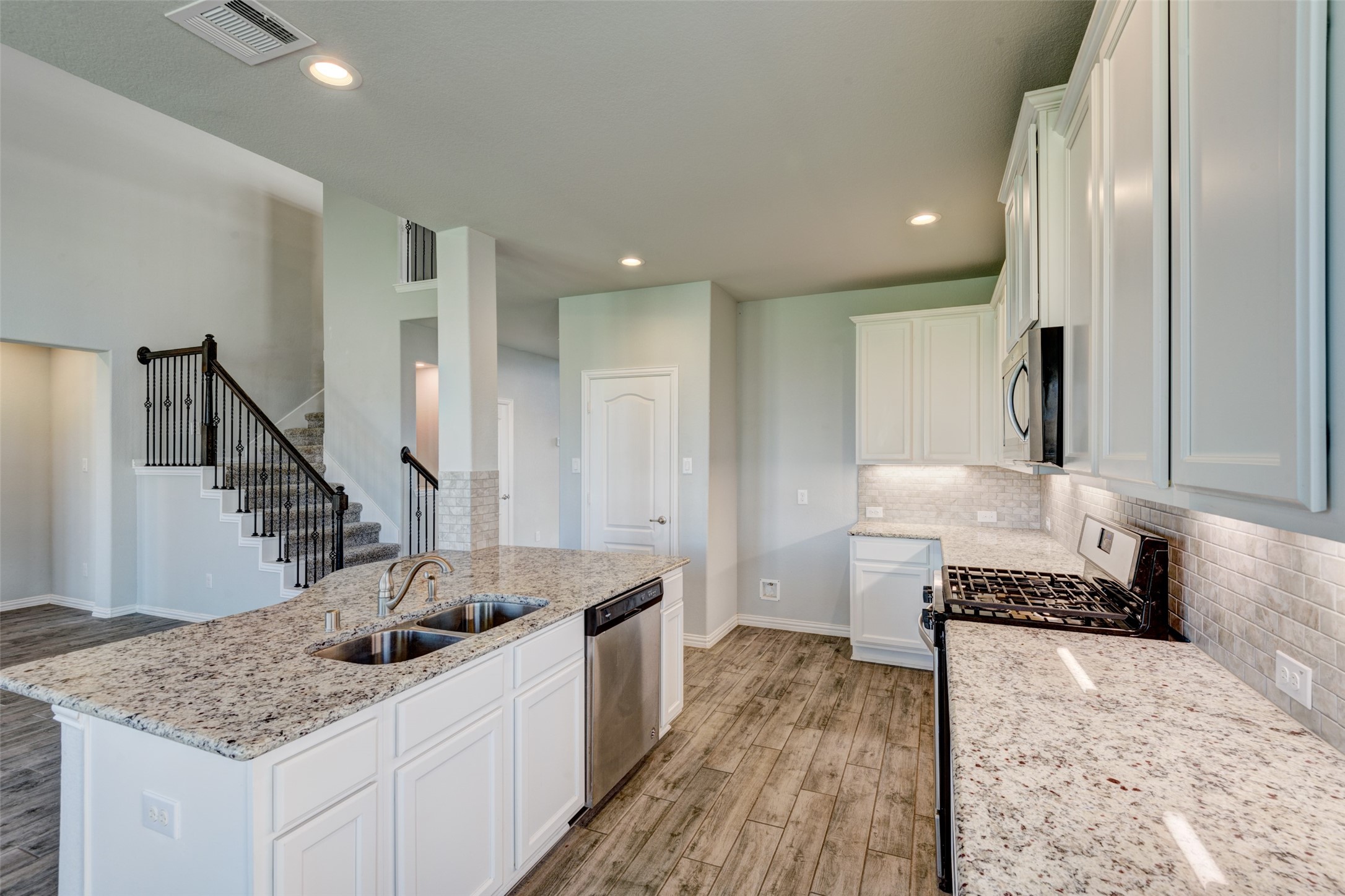 23421 Vineyard Drive Alvin, TX 77511 - Photo 12 of 32 a kitchen with sink refrigerator and stove