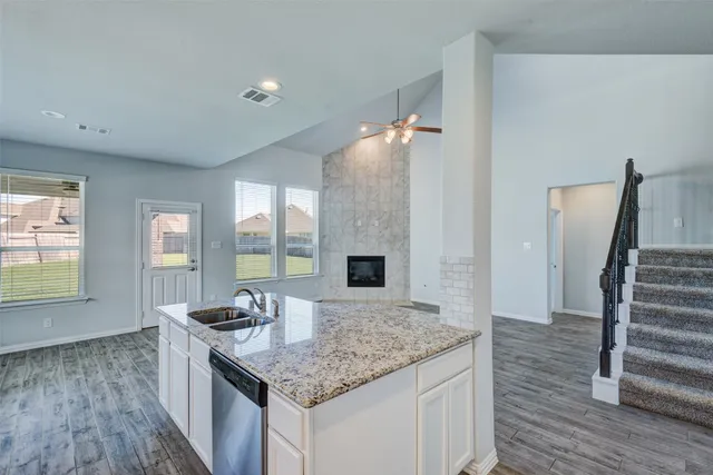a kitchen with stainless steel appliances granite countertop a sink stove and microwave