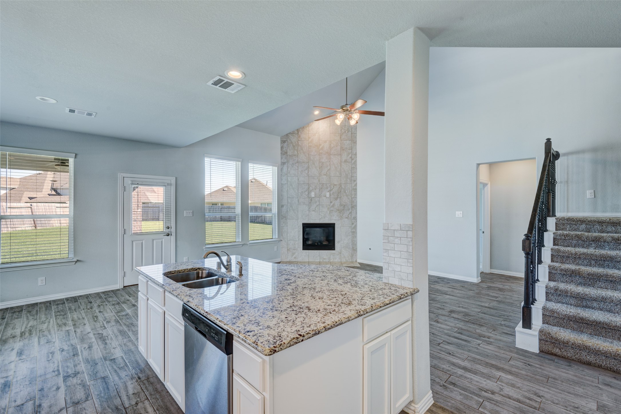 23421 Vineyard Drive Alvin, TX 77511 - Photo 13 of 32 a kitchen with granite countertop a sink stove and refrigerator