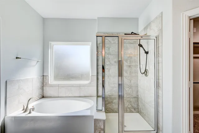 a bathroom with a bathtub and a shower