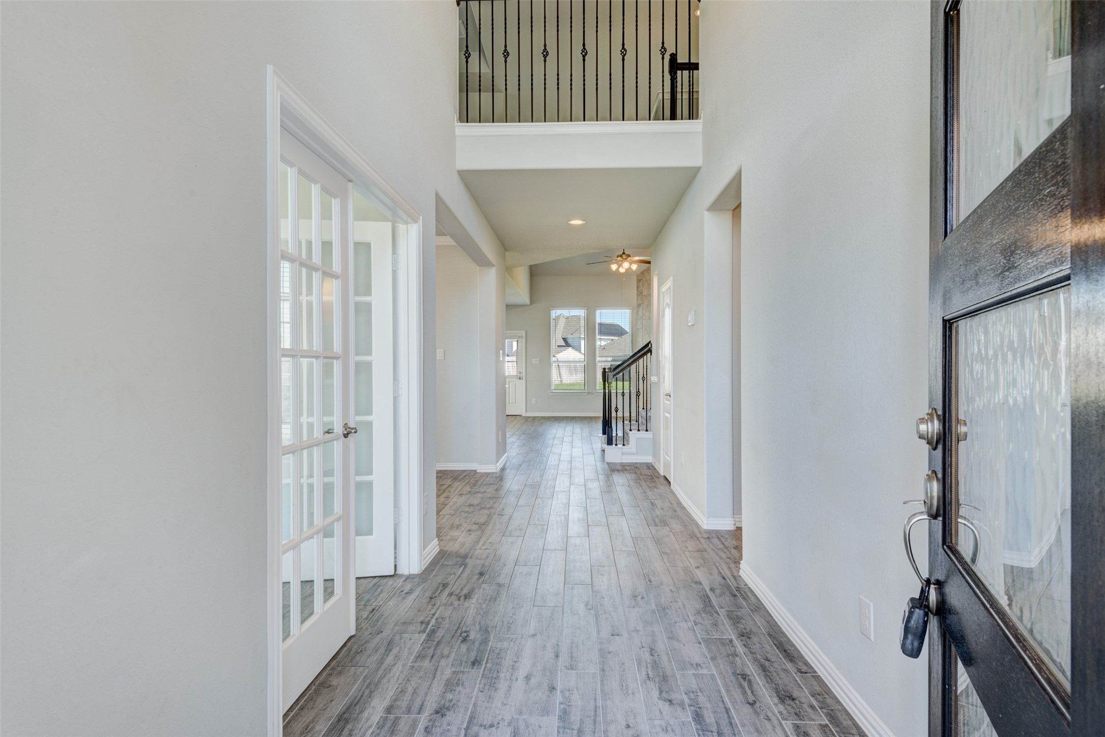 23421 Vineyard Drive Alvin, TX 77511 - Photo 2 of 32 a view of a hallway with wooden floor and staircase