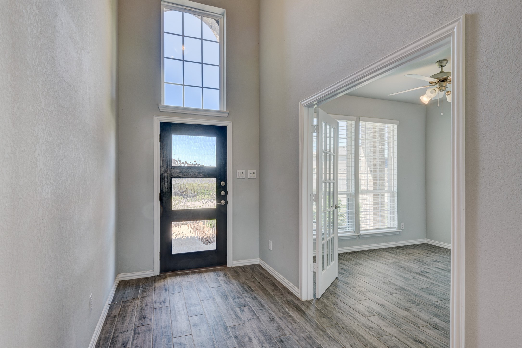 23421 Vineyard Drive Alvin, TX 77511 - Photo 3 of 32 an empty room with wooden floor closet and windows