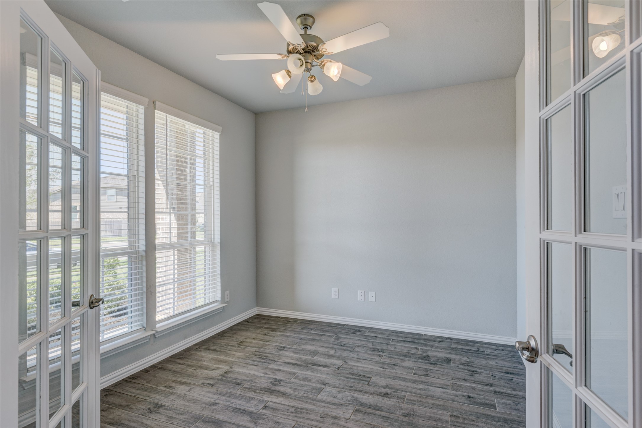 23421 Vineyard Drive Alvin, TX 77511 - Photo 4 of 32 a view of an empty room with window and wooden floor