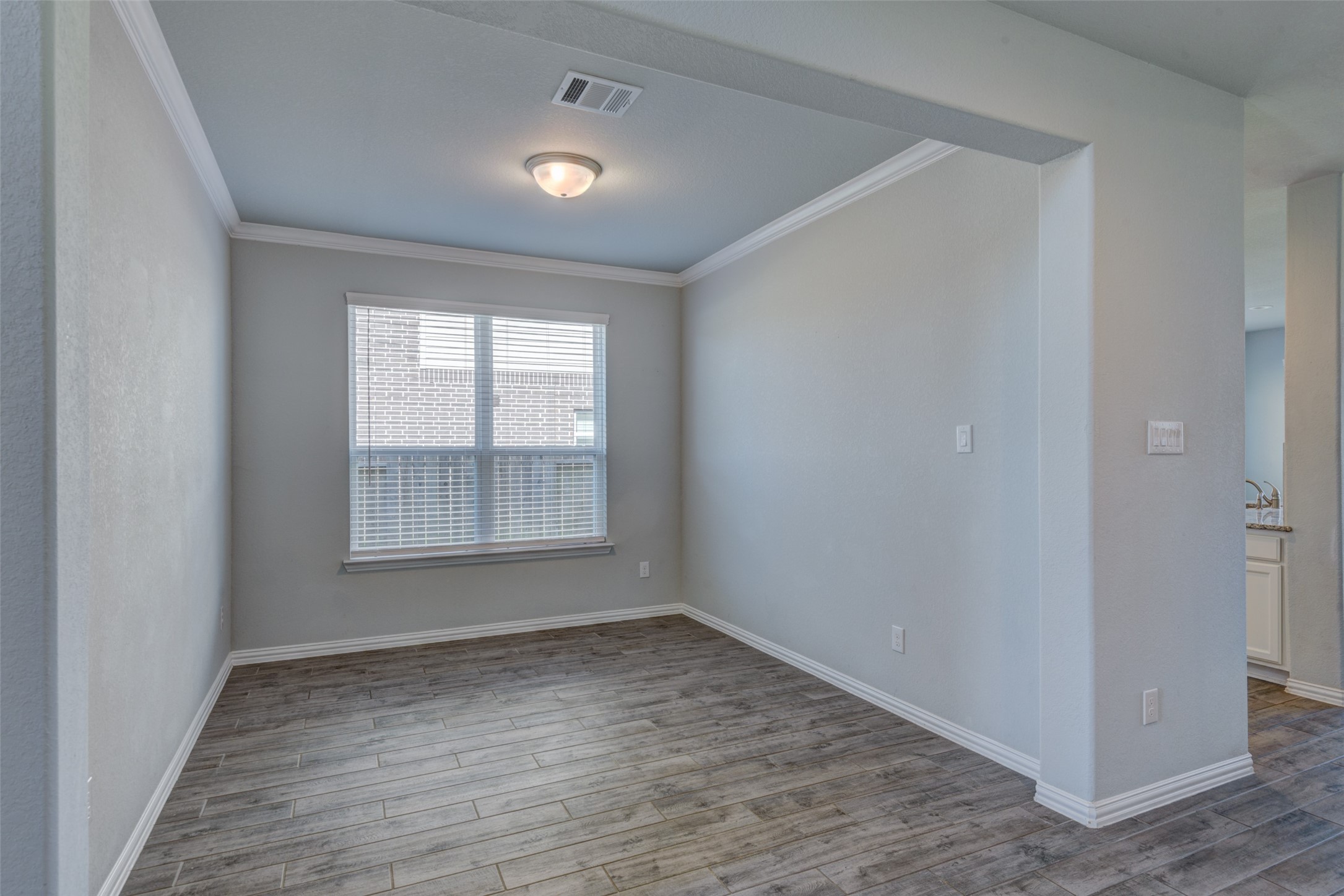 23421 Vineyard Drive Alvin, TX 77511 - Photo 5 of 32 an empty room with wooden floor and windows