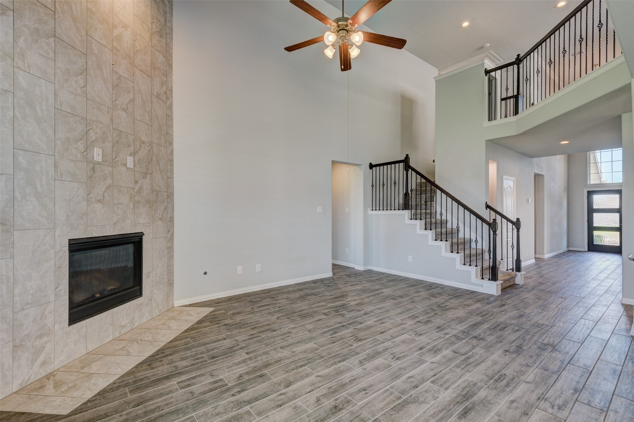 23421 Vineyard Drive Alvin, TX 77511 - Photo 9 of 32 a view of an entryway wooden floor and a fire place