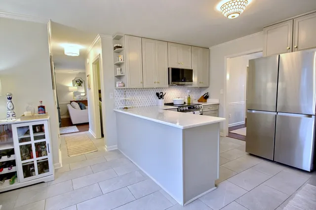 a kitchen with a refrigerator and a sink
