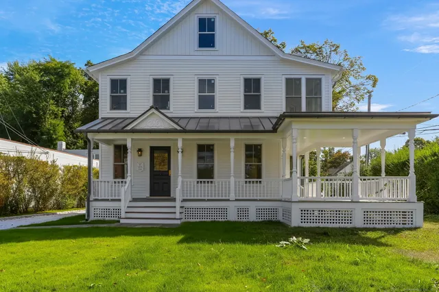 a front view of a house with a garden