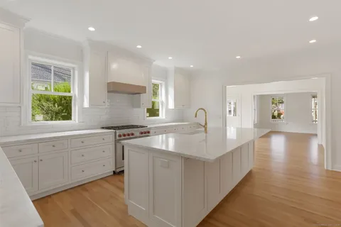 a kitchen with counter top oven sink and stove
