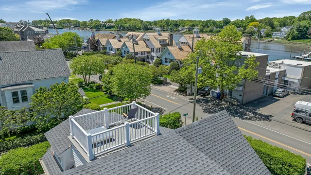 an aerial view of a house with garden space and lake view