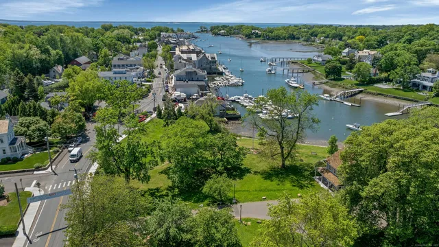 an aerial view of lake residential house with outdoor space and trees around