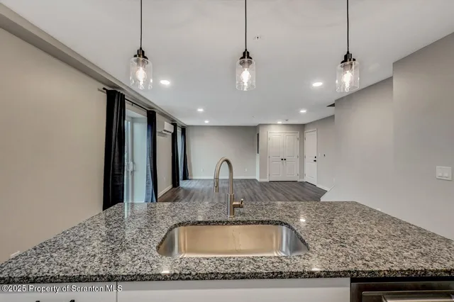 a kitchen with kitchen island granite countertop a sink and center island