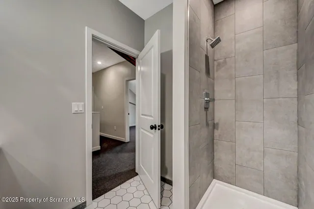 a bathroom with a sink a light fixture and a mirror