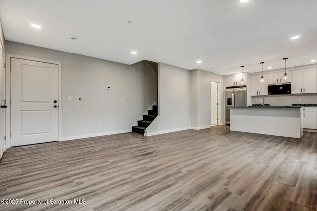 a view of a kitchen with a sink and a refrigerator