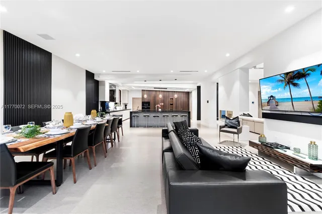 a large kitchen with kitchen island a large window in it