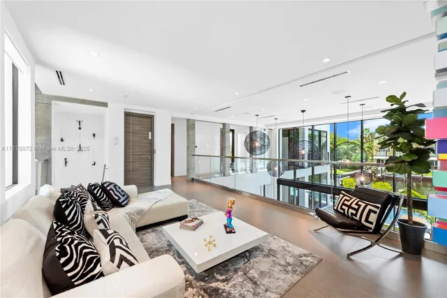 a living room with furniture flat screen tv and a large window