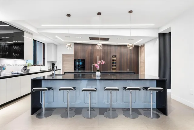 a very nice looking room with a large window and potted plants