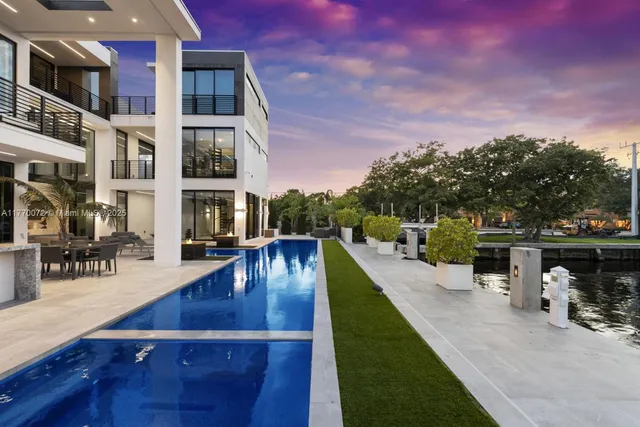 a living room with furniture pool table and a fireplace