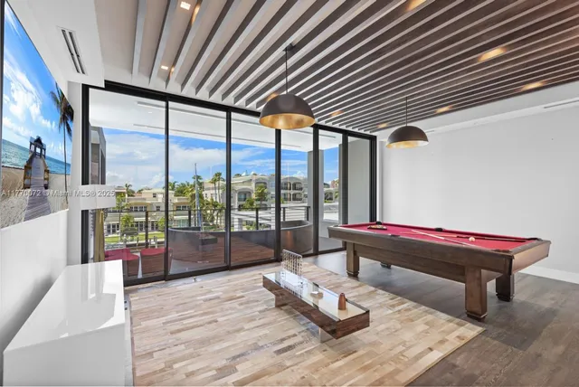 a view of a balcony with dining table and chairs