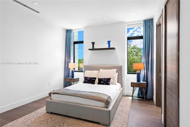 a living room with patio furniture and a floor to ceiling window