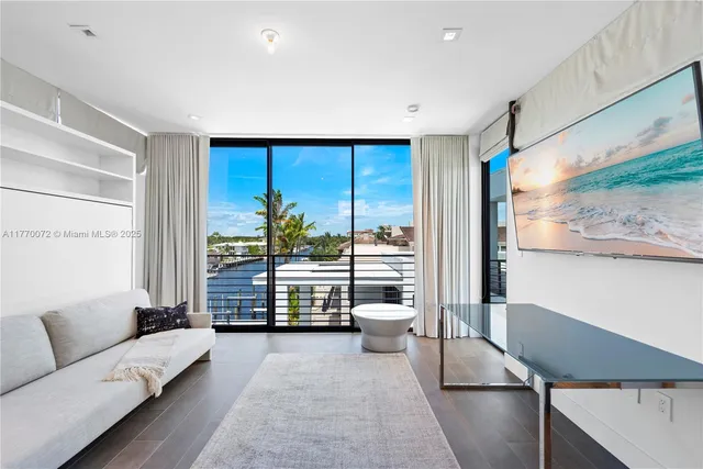 an aerial view of residential houses with outdoor space and river